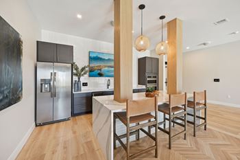 A modern kitchen with a dining table and chairs.